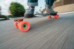 Skateboard Rolling On Pavement