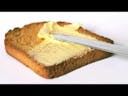 Spreading butter on toast 