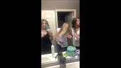 Blonde girl burns hand with curling iron