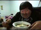 asian laughs while eating