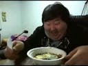 asian laughs while eating