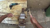 Hitting metal with hammer 